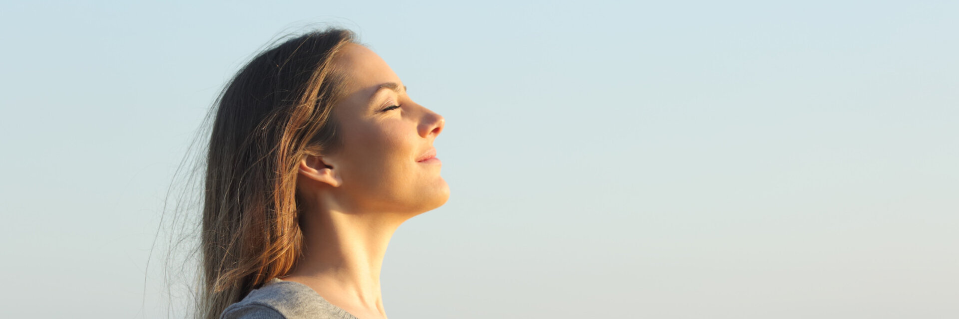 Side view portrait of a relaxed woman breathing fresh air on the beach