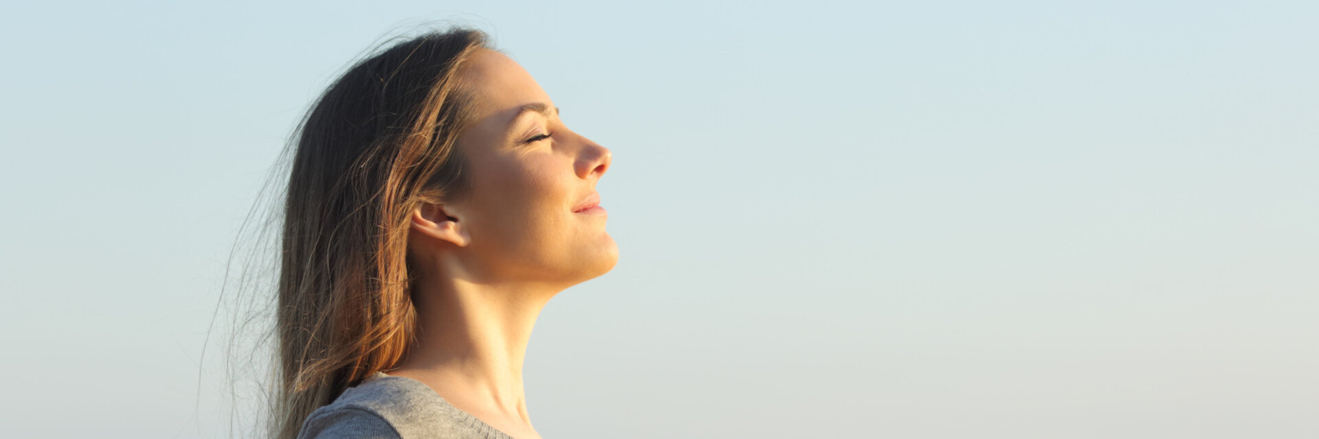 Side view portrait of a relaxed woman breathing fresh air on the beach
