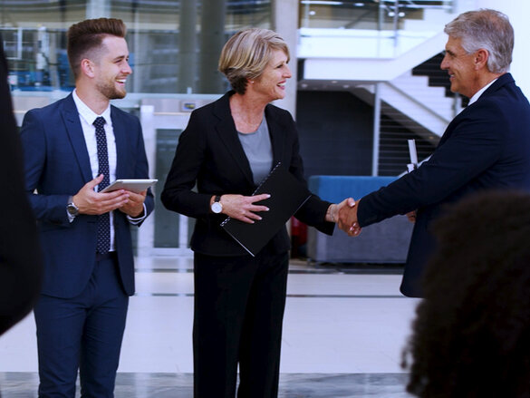 business women and men shaking hands