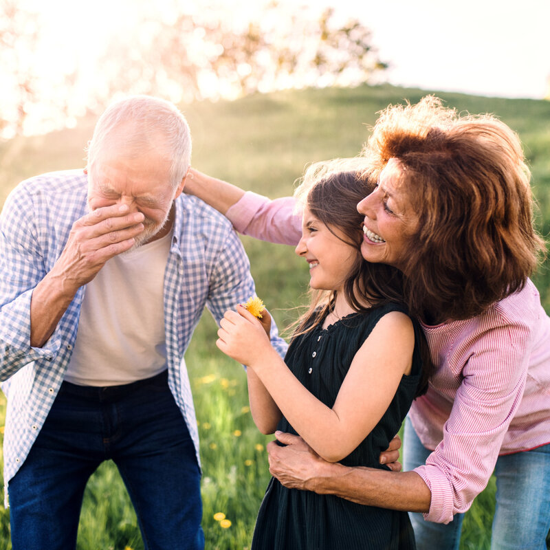Happy family enjoying the park during pollen season